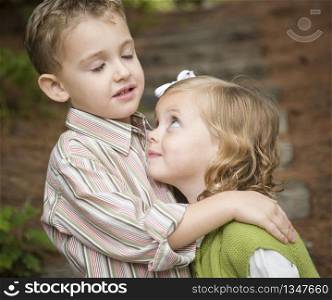 Adorable Brother and Sister Children Hugging Each Other Outside.