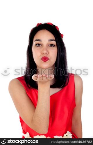 Adorable brunette girl with a elegant red cocktail dress throwing a kiss isolated on a white background