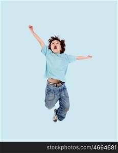 Adorable child jumping on a blue background