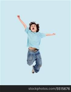 Adorable child jumping on a blue background