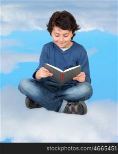 Adorable child reading sitting on the clouds