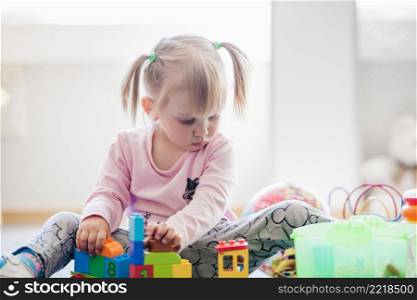 adorable child with toys playroom