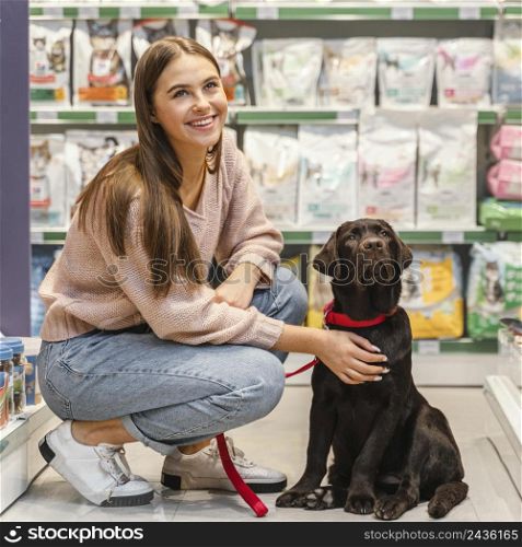 adorable dog with female owner pet shop