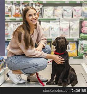 adorable dog with female owner pet shop