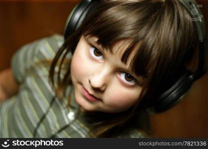 Adorable five year old wearing headphones.