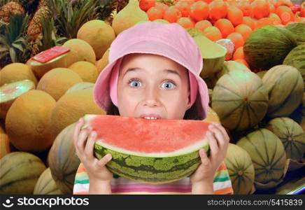 Adorable girl eating watermelon in the greengrocers