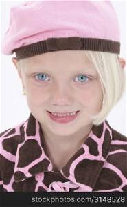 Adorable girl in pink barret with blonde hair and big blue eyes.