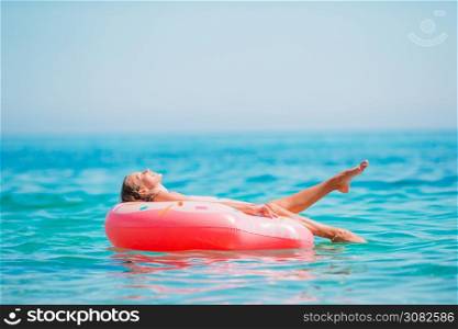 Adorable girl on inflatable air mattress in the clear sea. Adorable girl on inflatable air mattress in the sea