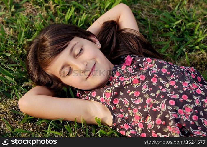 Adorable girl relaxed on the green grass