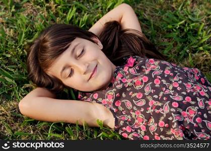Adorable girl relaxed on the green grass
