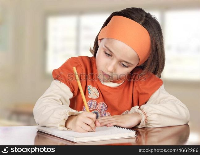Adorable girl studying in the school with a window of background