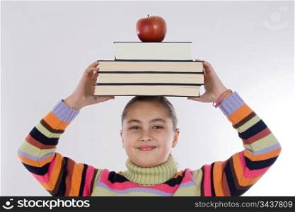 Adorable girl studying with books and apple in the head