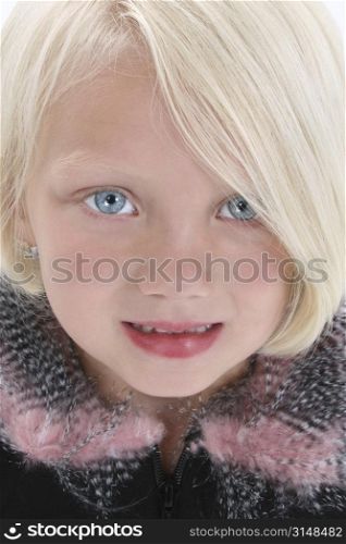 Adorable girl with blonde hair and big blue eyes.