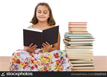 Adorable girl with many books reading on wooden floor