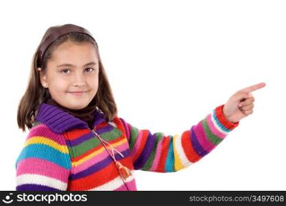 Adorable girl with woollen jacket pointing on a over white background