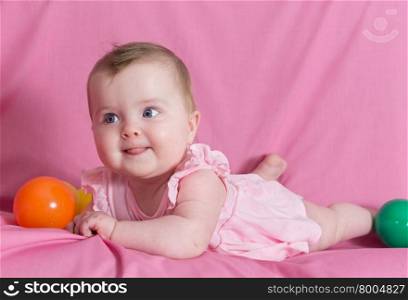 Adorable happy baby girl on pink background