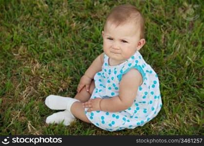 adorable happy baby on the green grass