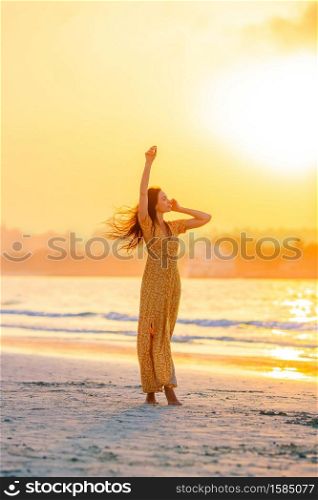 Adorable happy little girl on white beach at sunset. Beautiful woman on white beach at sunset.