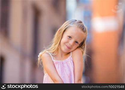 Adorable happy little girl outdoors in european city. Portrait of caucasian kid enjoy summer vacation in Rome. Adorable happy little girl outdoors in italian city. Portrait of caucasian kid enjoy summer vacation in Rome