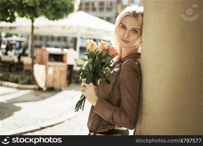 Adorable lady with a bouquet of roses