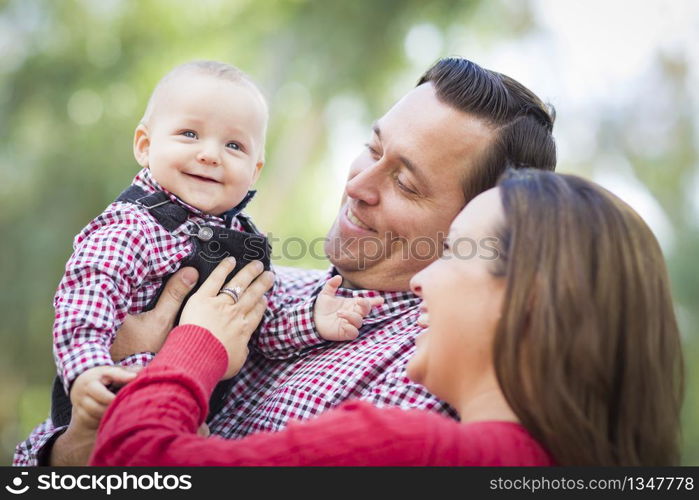 Adorable Little Baby Boy Having Fun With Mother and Father Outdoors.