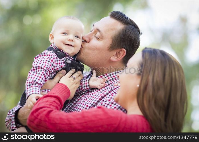 Adorable Little Baby Boy Having Fun With Mother and Father Outdoors.