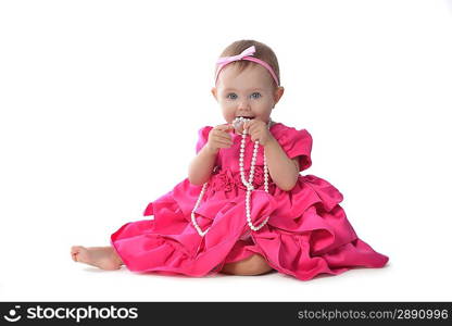 Adorable little baby girl in pink dress sitting on floor