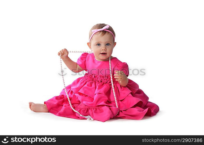 Adorable little baby girl in pink dress sitting on floor