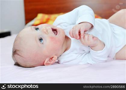 Adorable little baby on parent bed