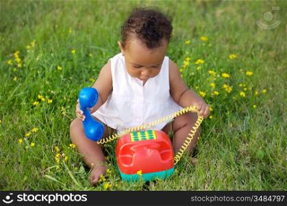 Adorable little black girl with big phone
