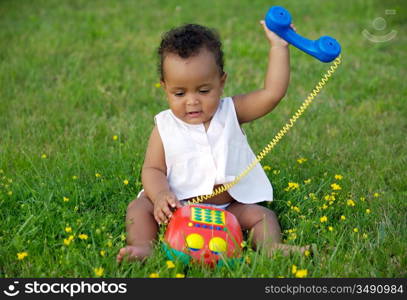 Adorable little black girl with big phone