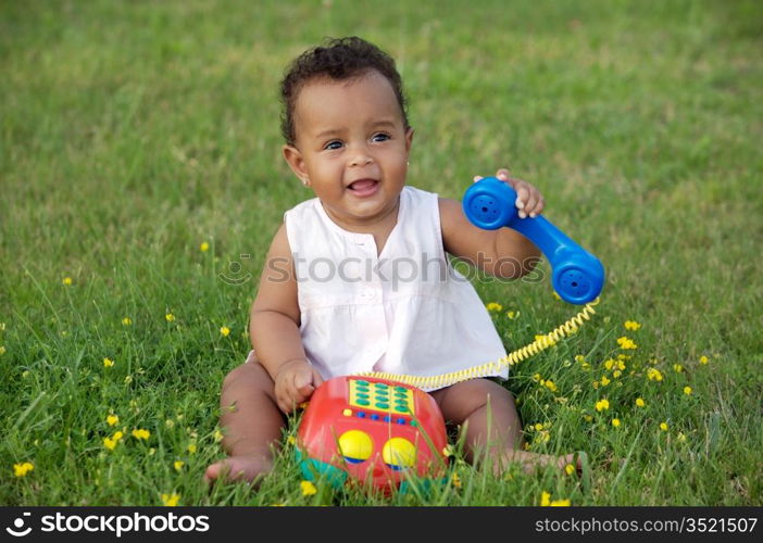 Adorable little black girl with big phone
