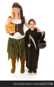 Adorable little boy in halloween costume getting ready to trick or treat with his sister. Full body isolated on white.
