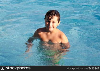 Adorable little boy swiming in the swimming-pool