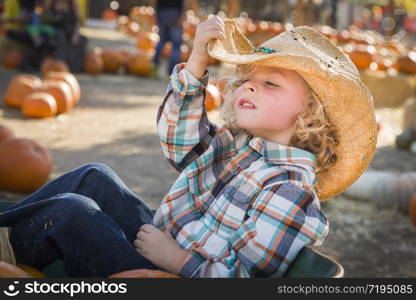 Adorable Little Boy Wearing Cowboy Hat at Pumpkin Patch Farm.