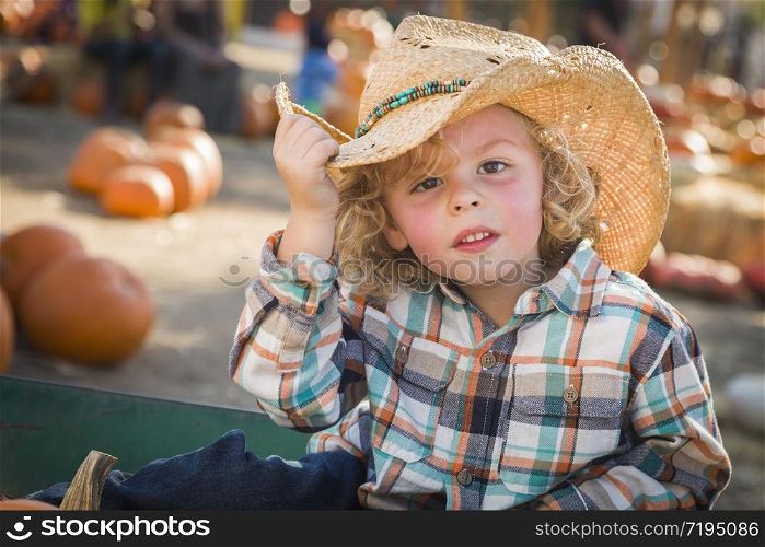 Adorable Little Boy Wearing Cowboy Hat at Pumpkin Patch Farm.