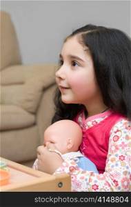adorable little brunette girl playing with doll. adorable little girl holding a doll