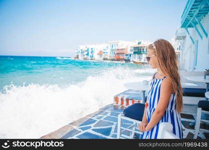 Adorable little girl at old street of typical greek traditional village on Mykonos. Adorable little girl at old street of typical greek traditional village