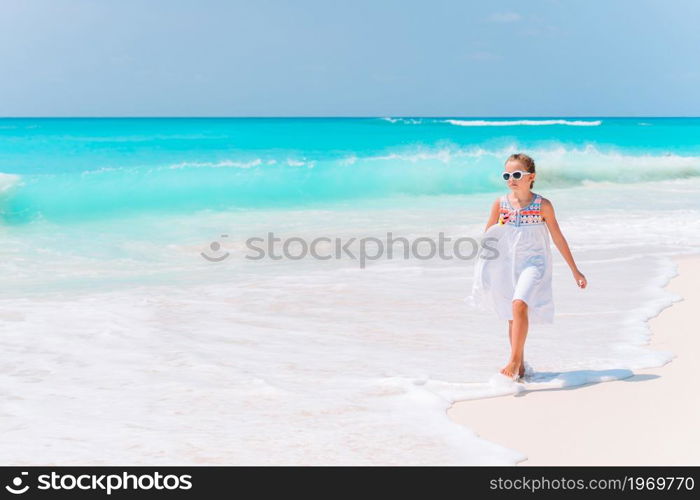 Adorable little girl at tropical beach on vacation. Adorable little girl have fun at tropical beach during vacation