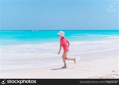 Adorable little girl at tropical beach on vacation. Adorable little girl have fun at tropical beach during vacation