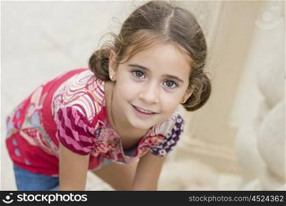 Adorable little girl combed with pigtails outdoors.