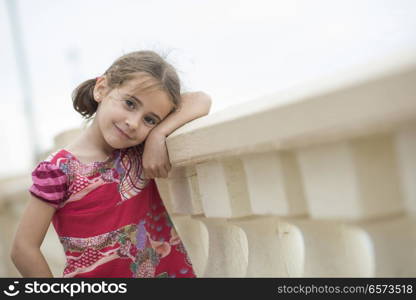 Adorable little girl combed with pigtails outdoors.