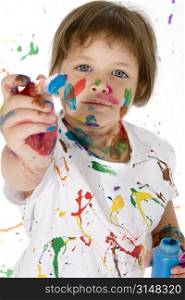 Adorable little girl covered in bright paint.
