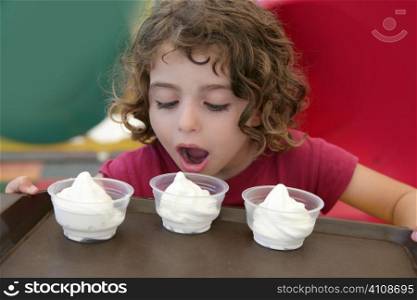 Adorable little girl holding tray with three ice cream over colorful background