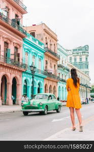 Adorable little girl in popular street in Old Havana, Cuba.. Tourist girls in popular area in Havana, Cuba. Young woman traveler smiling