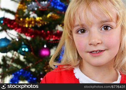 adorable little girl near Christmas fir-tree.