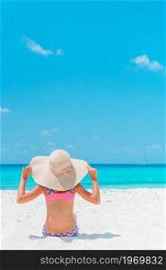 Adorable little girl on the beach. Happy girl enjoy summer vacation background the blue sky and turquoise water in the sea. Happy girl enjoy summer vacation on the beach