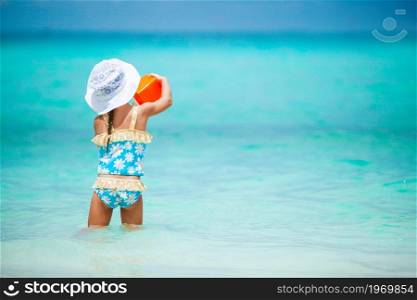 Adorable little girl playing with toys on beach vacation. Adorable little girl playing with beach toys on white tropial beach