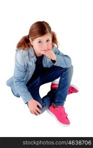 Adorable little girl sitting on the floor with denim shirt isolated on a white background
