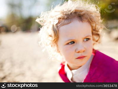 Adorable little girl taken closeup outdoors in summer